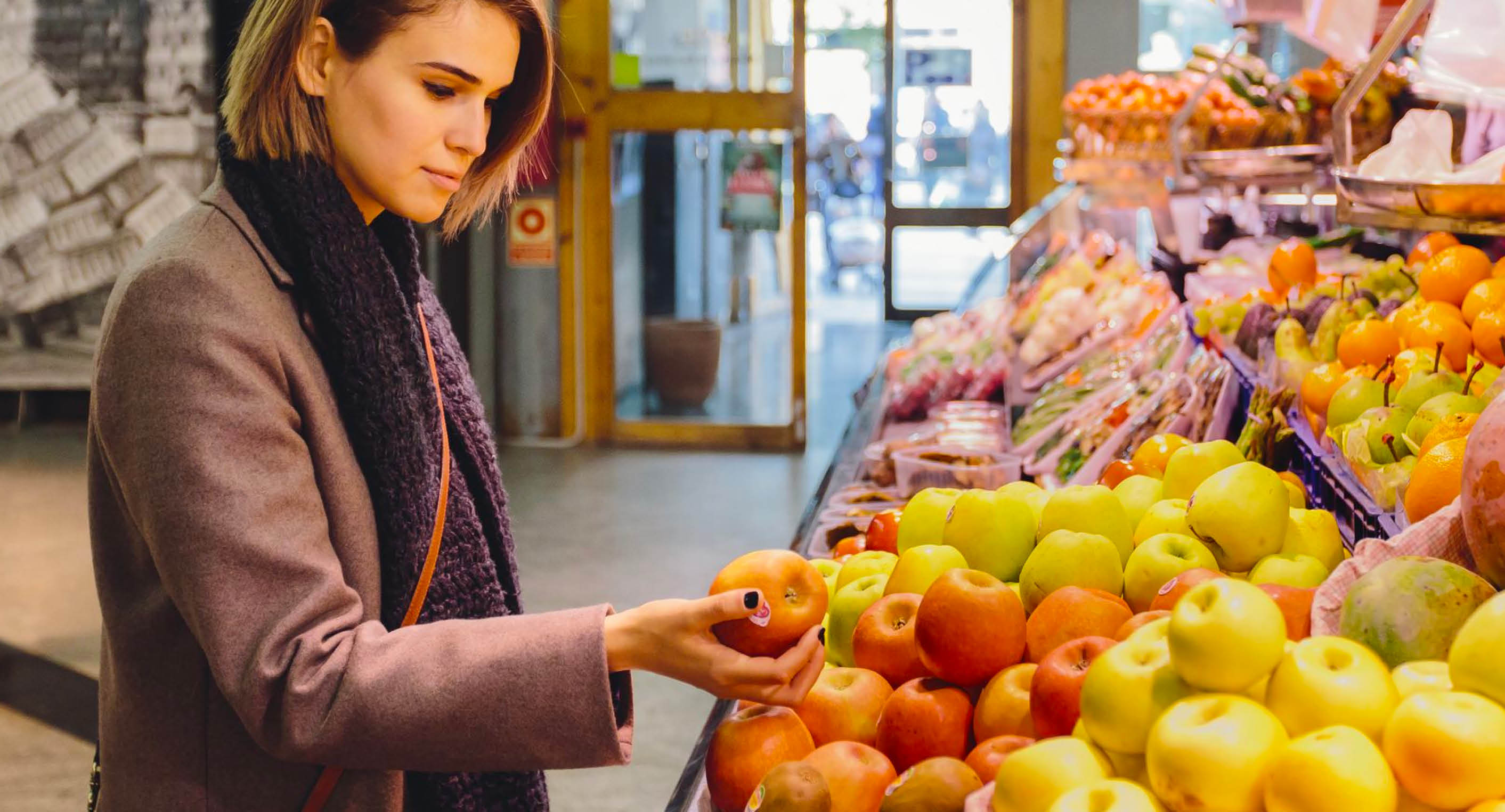 Girl deciding whether to get fruits or not