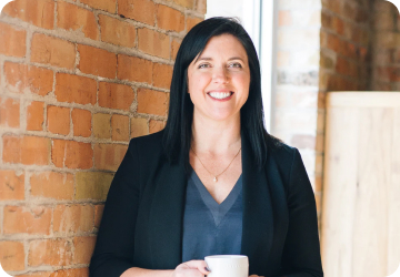 Woman smiling and holding a mug